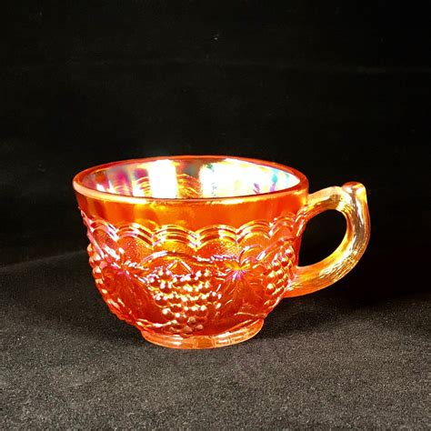 of 50. . Carnival glass tea cups